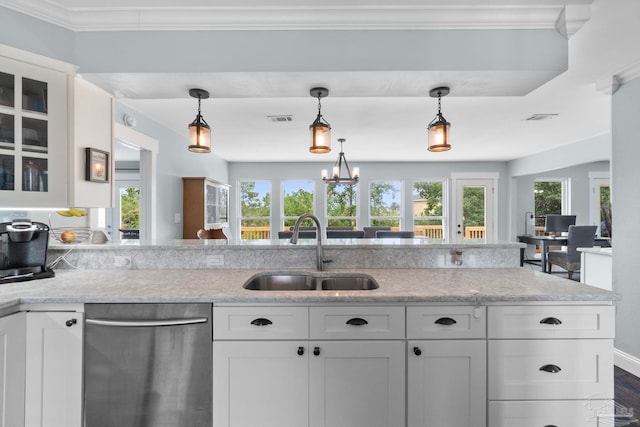 kitchen with a healthy amount of sunlight, sink, stainless steel dishwasher, and white cabinetry