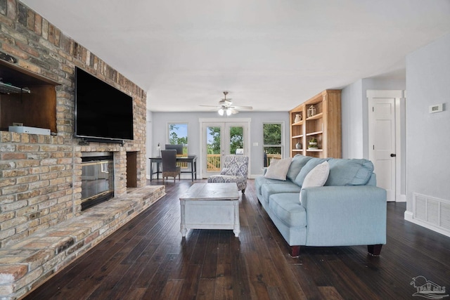 living room featuring a brick fireplace, ceiling fan, and dark hardwood / wood-style flooring