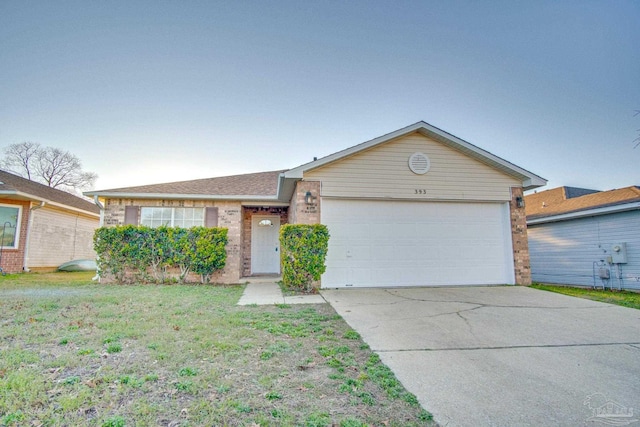 single story home with a garage, driveway, brick siding, and a front lawn