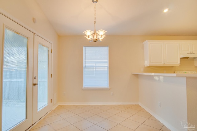 unfurnished dining area with french doors, light tile patterned flooring, baseboards, and an inviting chandelier