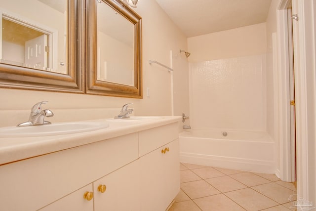 full bathroom featuring double vanity, shower / bathing tub combination, a sink, and tile patterned floors