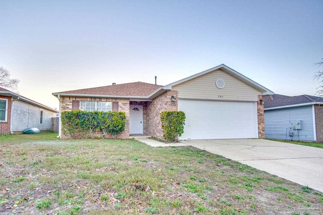 single story home featuring driveway, brick siding, an attached garage, and a front yard