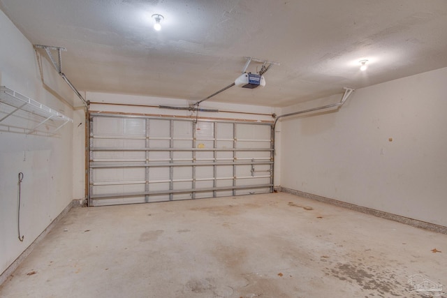 garage with baseboards and a garage door opener