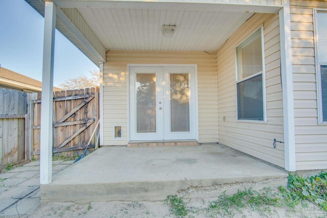 doorway to property featuring a gate, a patio area, and fence