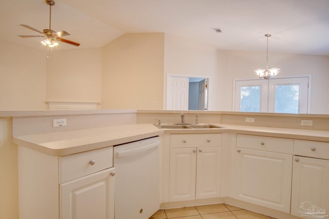 kitchen with vaulted ceiling, white dishwasher, light countertops, and a sink