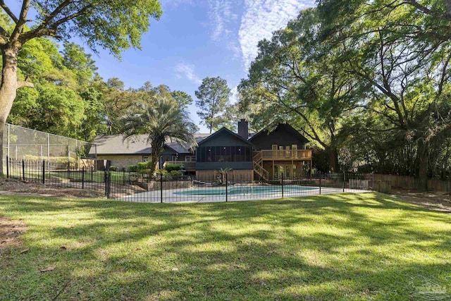 view of pool featuring a lawn