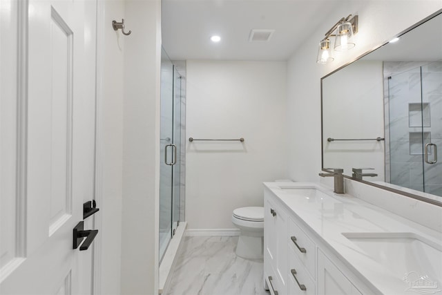 bathroom with vanity, toilet, and a shower with door