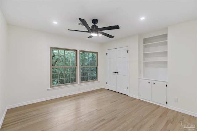 unfurnished bedroom with ceiling fan and light hardwood / wood-style flooring