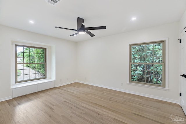 unfurnished room featuring ceiling fan and light wood-type flooring