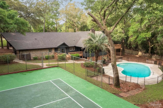 view of property's community featuring a pool and tennis court