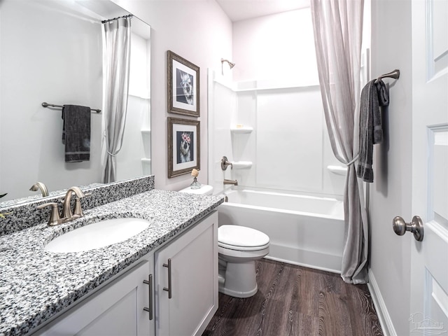 full bathroom featuring vanity, hardwood / wood-style flooring, toilet, and shower / bath combo with shower curtain