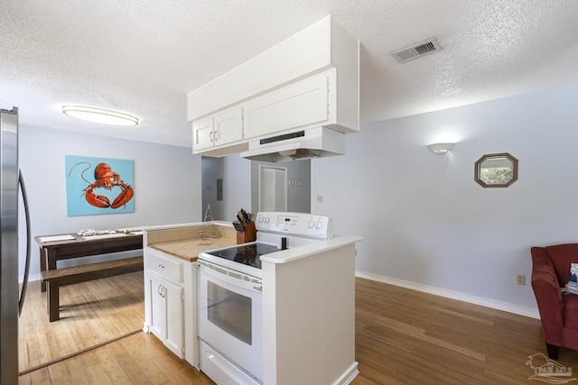 kitchen featuring white cabinetry, wood-type flooring, white electric range oven, and stainless steel fridge