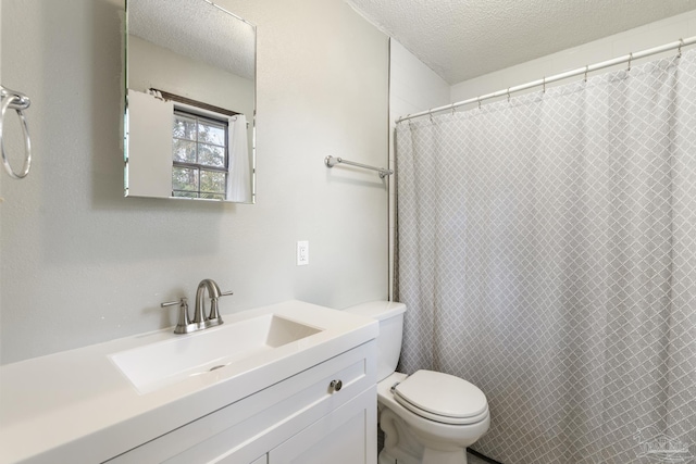 bathroom with vanity, a textured ceiling, and toilet