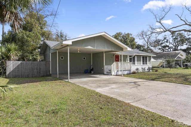 view of front of home with a carport and a front lawn