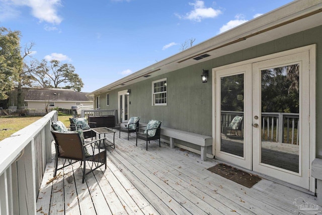 wooden deck with french doors and outdoor lounge area