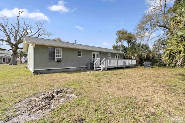 back of house with cooling unit, a yard, and a deck