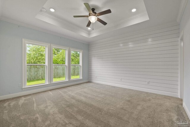unfurnished room featuring recessed lighting, a tray ceiling, ornamental molding, and a ceiling fan
