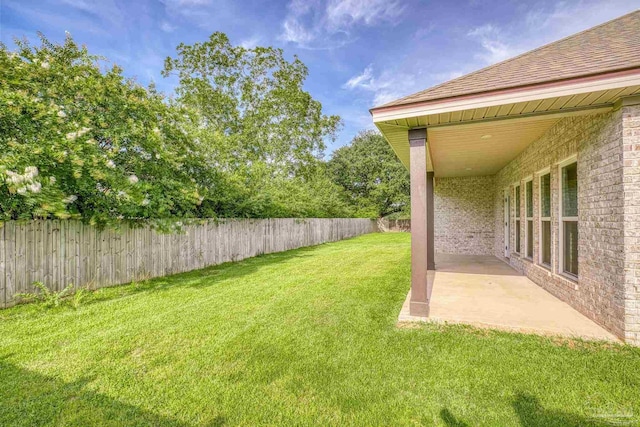 view of yard with a patio area and a fenced backyard