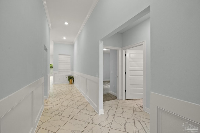 corridor with wainscoting, marble finish floor, ornamental molding, and recessed lighting
