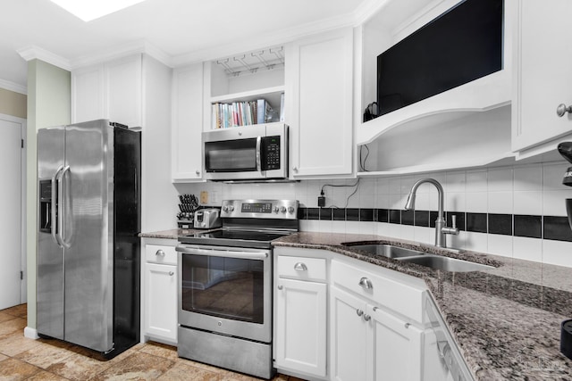 kitchen with dark stone countertops, appliances with stainless steel finishes, sink, and white cabinets