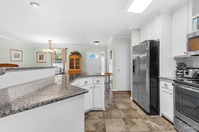 kitchen with hanging light fixtures, dark stone counters, ornamental molding, stainless steel appliances, and white cabinets