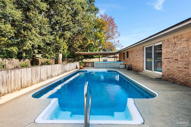 view of pool featuring a patio area and a hot tub