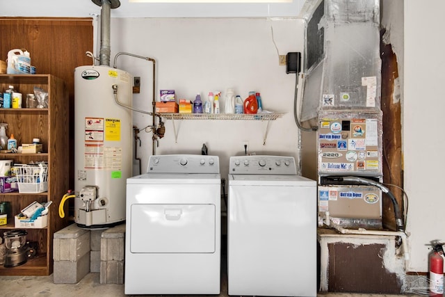 washroom with gas water heater and washing machine and clothes dryer