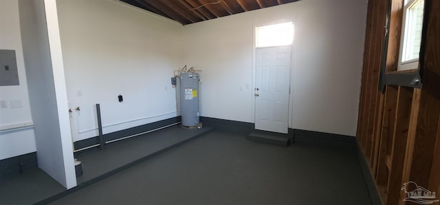 exercise room featuring electric panel and electric water heater