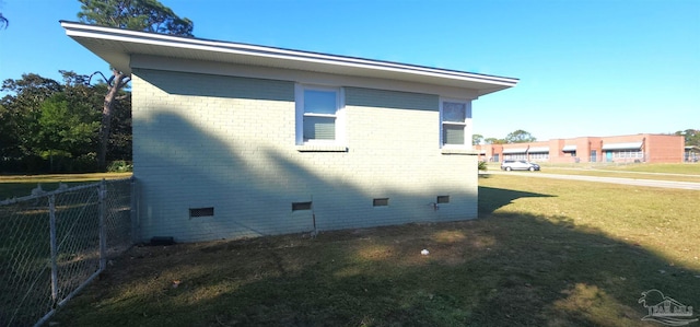 view of side of home with a lawn