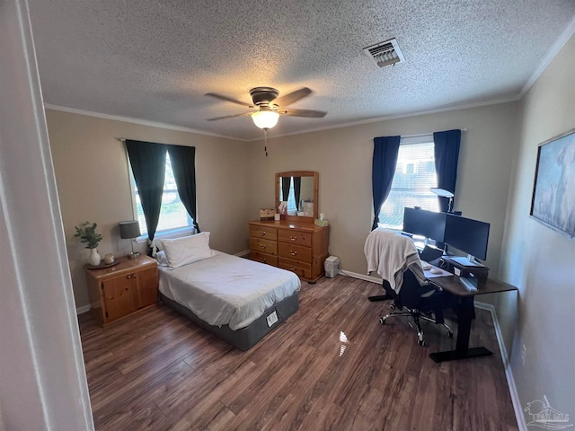 bedroom with dark hardwood / wood-style floors, ceiling fan, crown molding, and a textured ceiling