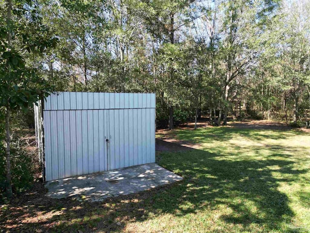 view of outbuilding with a yard