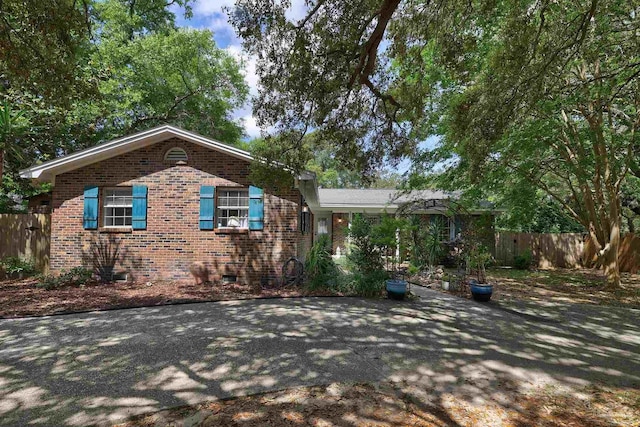 view of front of house with brick siding and fence