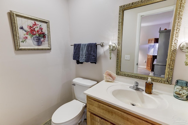 half bath featuring toilet and vanity