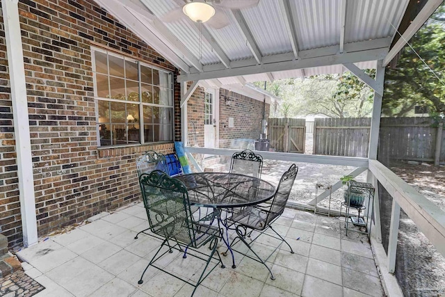 view of patio featuring ceiling fan, fence, and outdoor dining area