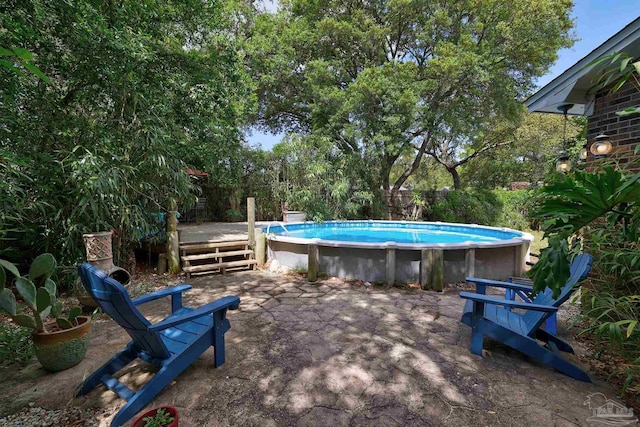 outdoor pool with a wooden deck