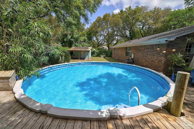 pool with a wooden deck and an outdoor structure