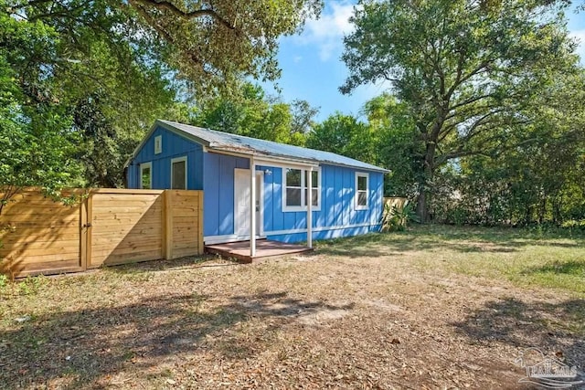 view of outdoor structure with a gate and fence