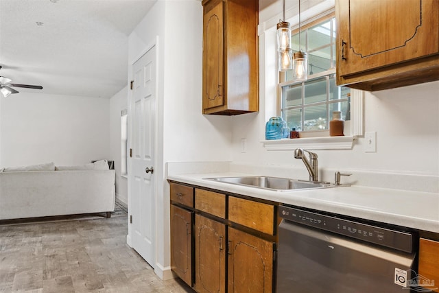 kitchen with decorative light fixtures, dishwasher, sink, ceiling fan, and light hardwood / wood-style flooring