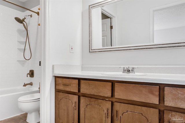 full bathroom featuring vanity, tiled shower / bath, and toilet