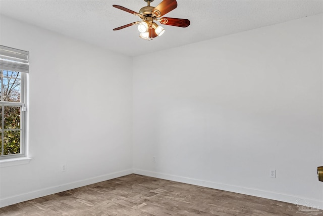 unfurnished room with ceiling fan, plenty of natural light, light hardwood / wood-style flooring, and a textured ceiling