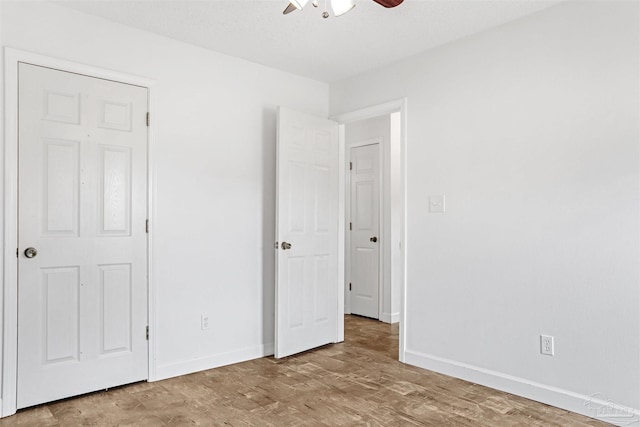 unfurnished bedroom with wood-type flooring and ceiling fan