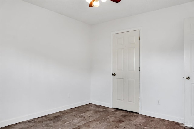 spare room with ceiling fan and dark hardwood / wood-style floors