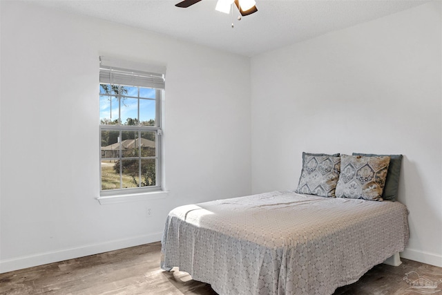 bedroom featuring wood-type flooring and ceiling fan