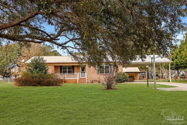 ranch-style home featuring a front yard, a carport, and covered porch