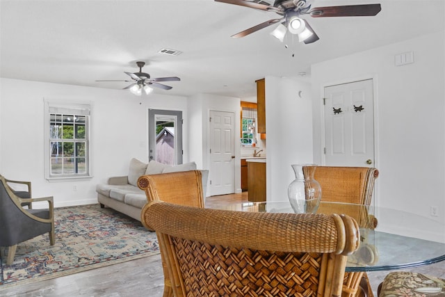 dining area featuring ceiling fan and light hardwood / wood-style flooring