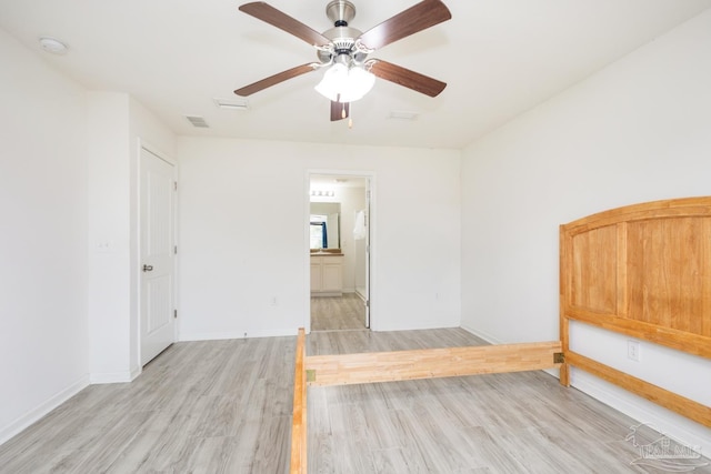 spare room with a ceiling fan, baseboards, visible vents, and light wood finished floors