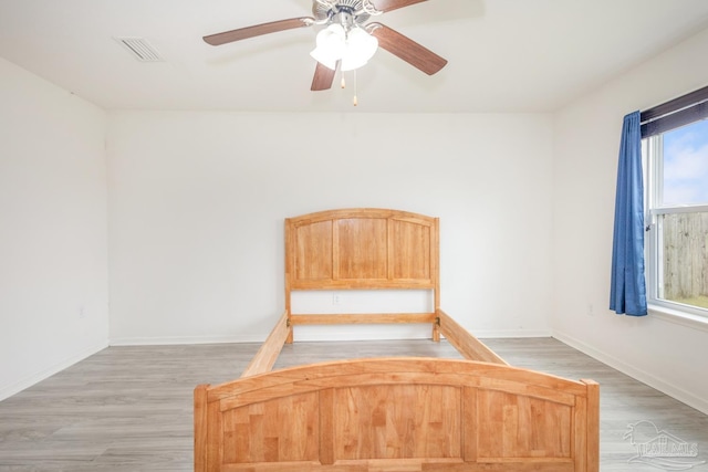 unfurnished bedroom featuring visible vents, light wood-type flooring, and baseboards