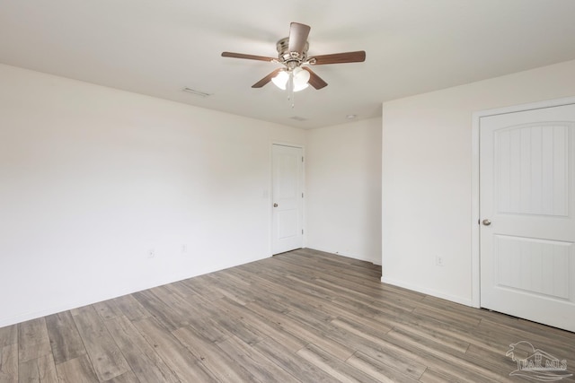 unfurnished room with wood finished floors and ceiling fan