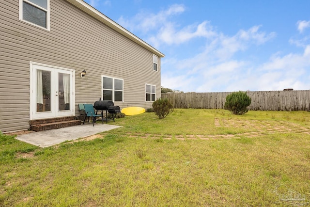 view of yard with french doors, a patio area, and fence