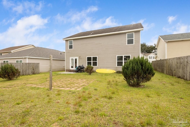 back of house with a lawn, a patio, and a fenced backyard